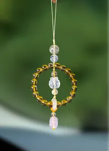Macro view of a crystal car hanging ornament featuring citrine beads and a carved Pixiu