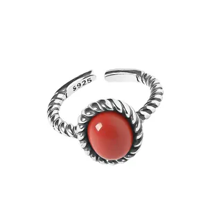 Vintage 925 sterling silver woven ring featuring a large oval red gemstone.