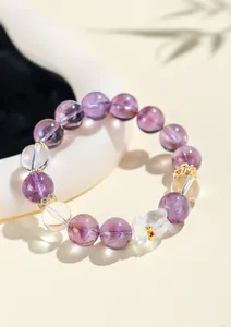 Detail view of amethyst and clear quartz bracelet with a cute crystal bear charm