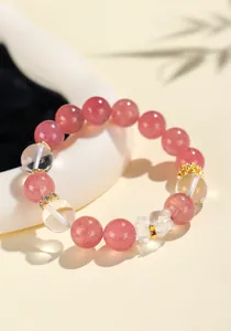 Detail view of pink strawberry quartz and clear crystal beaded bracelet with bear charm