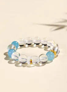 Clear white crystal beaded bracelet with cute bear charm and golden accents for women
