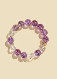 Close-up of elegant purple and white crystal beaded bracelet featuring a cute bear charm
