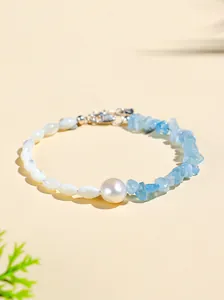 Close-up detail of irregular aquamarine and pearl bracelet with silver clasp