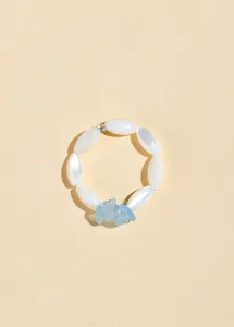 Macro view of aquamarine stones and white marquise beads on a summer bracelet