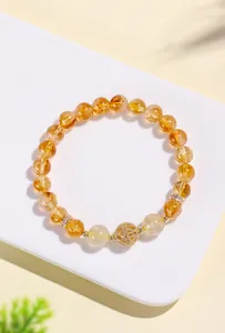 High-quality detail shot of a natural yellow crystal bracelet with gold quartz beads.