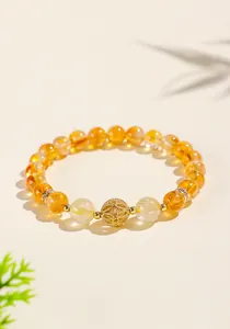 Close-up of natural citrine and golden rutile quartz bracelet with golden filigree bead