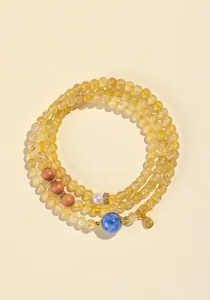 Detalle del collar de cuentas de cuarzo rutilado natural con detalles azules y perlas