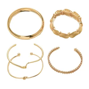 Set of four elegant gold-toned metal bracelets with minimalist and textured designs
