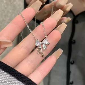 Elegant dainty silver bow pendant necklace with sparkling zirconia and star charms