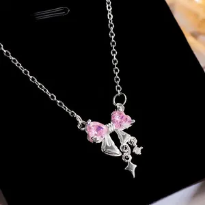 Detailed view of a stylish pink heart-shaped bow necklace with dangling silver star pendant