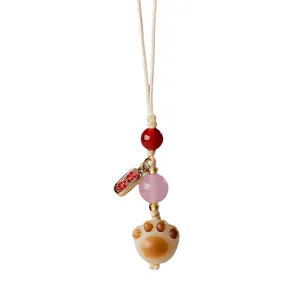 Pendentif artisanal patte de chat avec graine de Bodhi et perles d'agate rose