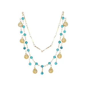 Elegante dubbellaagse gouden ketting met schelphangers en turkooisblauwe sierstenen