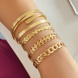Primo piano dettagliato di un elegante set di braccialetti placcati in oro donna