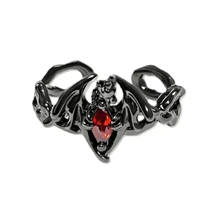 Detailed view of gothic bat wing open ring with a central red marquise gemstone.