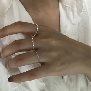 Primo piano di tre anelli minimalisti in argento sterling testurizzato sulle dita
