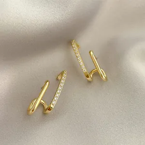 Detailed close-up of elegant gold-plated double-hoop earrings with sparkling crystals.