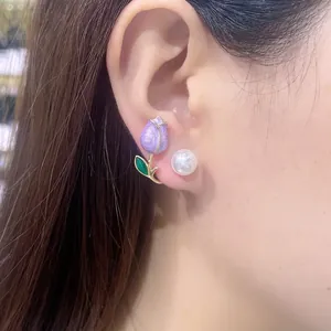 Detailed close-up showing a stylish purple tulip and white pearl earring worn on an earlobe