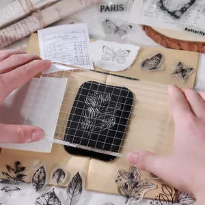 Close-up of vintage butterfly and floral clear silicone stamps with acrylic handle for DIY journaling