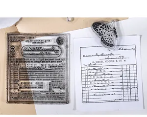 Macro detail of vintage clear silicone stamps showing intricate butterfly and receipt patterns