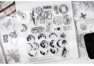 Close-up of vintage transparent silicone stamps featuring moon phases and postage patterns.