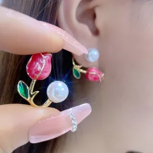 Close-up detail of elegant pink tulip earrings with pearls showing the versatile two-way wear design