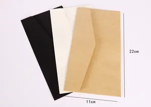 Detail showing 11x22cm dimensions of vintage kraft, black, and cream envelopes