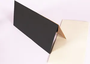 Detailed view of minimalist black and beige Western size 5 envelopes on a light background