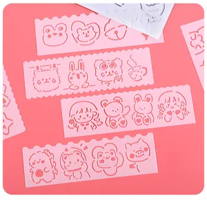 Detailed view of pink cartoon hollowed-out drawing stencils for DIY scrapbooking