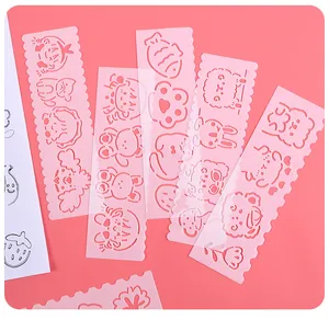 Detail view of pink plastic drawing stencils featuring cute hollow cartoon animal shapes