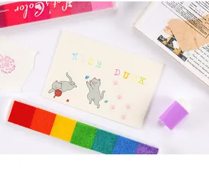 Detailed view of six-color rainbow gradient ink pad with stamped cute cat card