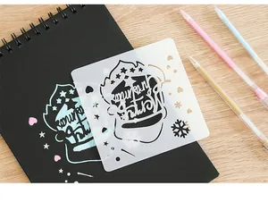 Detailed view of a crown-shaped plastic drawing stencil used on a black art notebook.