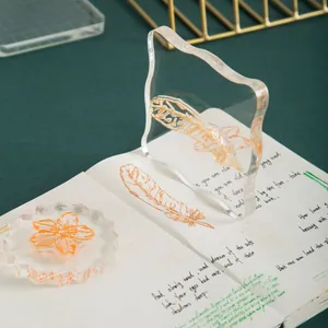 Clear acrylic stamp blocks with feather and flower designs for creative journaling.