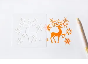 Detail of Christmas reindeer stencil template with orange marker drawing on white paper.