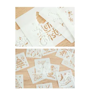 Close-up of hollowed-out Christmas stencils featuring Merry Christmas and tree patterns