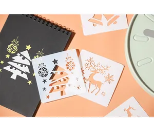 Macro view of white Christmas drawing stencils featuring reindeer and tree patterns