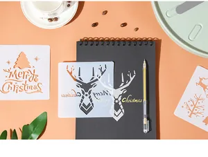 Close-up of a Christmas reindeer stencil on a black notebook with holiday designs