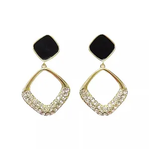 Elegant geometric gold-toned earrings with black accents and sparkling pave rhinestones.