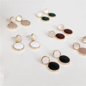Minimalist colorful round enamel stud earrings with gold plating shown in multiple vibrant shades.