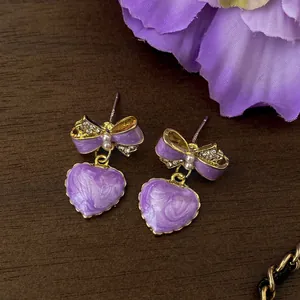 Detailed view of lavender heart bow earrings with gold-plated finish and S925 posts.