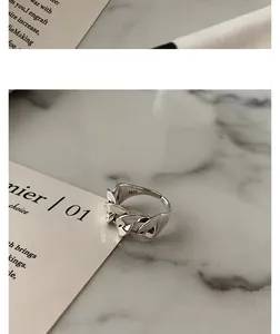 Detailed macro shot of vintage S925 silver twisted chain ring on marble background