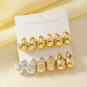 Detail view of a 3-pair waterdrop earring set in smooth and textured gold and silver finishes