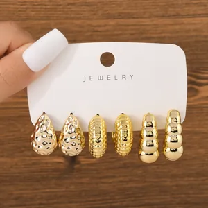 Set of three chunky gold-toned earrings including teardrop and textured C-hoop styles