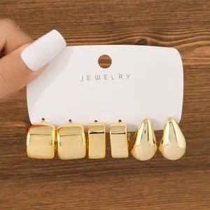 Set of three pairs of chunky gold-toned earrings featuring hoop and teardrop designs.