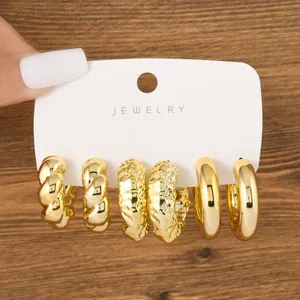 Detailed view of 3-piece chunky gold C-shaped hoop earring set on jewelry card