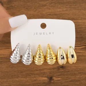 Detailed view of three-pair fashion earring set with metallic seashell and drop shapes.