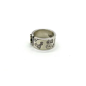 Macro view of retro 925 sterling silver ring with smile and dollar sign engravings