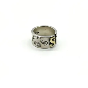 Macro view of vintage 925 sterling silver ring with engraved dollar signs.