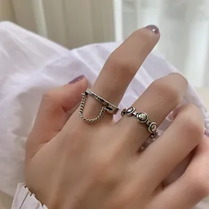 Detailed close-up showing S925 sterling silver rings with chain and SMILE engraving.
