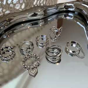 Detailed view of diverse S925 sterling silver rings with heart and chain elements