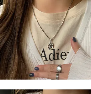 Detailopname van een vintage 925 sterling zilveren engel hanger ketting bij een model